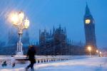 ロンドン中心部で２日、雪で覆われた橋を歩く人＝ロイター 